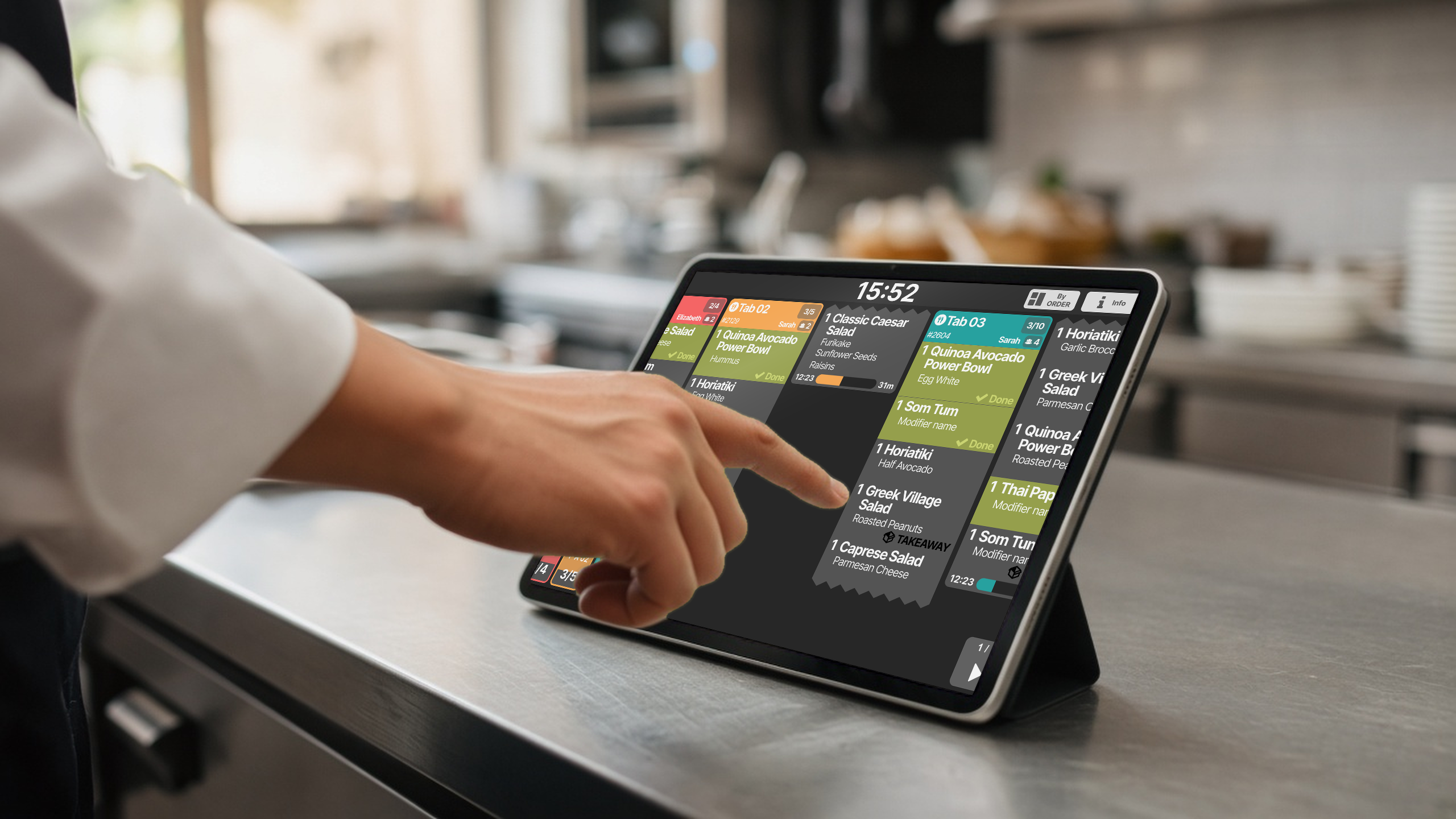 Chef tapping the KDS on an iPad